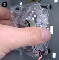 Fitting AFM02 antivibration ultra-soft fan mounts. Image 2 shows a clear low vibration fan (an AcoustiFan™ C-Series) being threaded from the inside of the PC onto fan mounts in position.